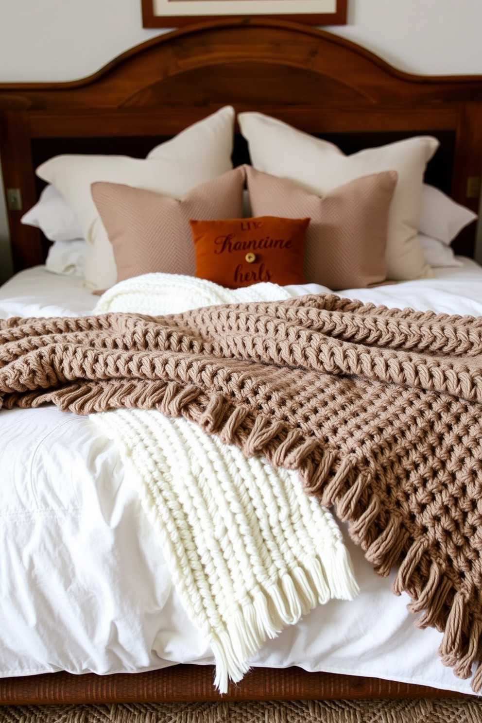 A cozy Thanksgiving bedroom setting featuring textured knit blankets draped over a plush bed. The blankets add warmth and comfort, complemented by soft, neutral-toned pillows and a rustic wooden headboard.