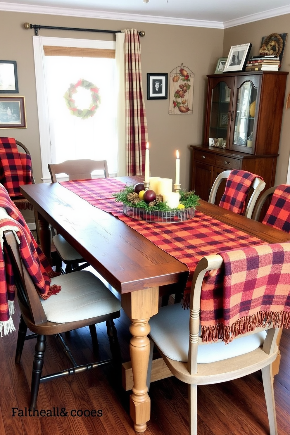 A cozy dining room setting featuring a rustic wooden table adorned with plaid table runners in warm autumn colors. Surrounding the table are mismatched chairs, each draped with soft throw blankets, creating an inviting atmosphere for Thanksgiving gatherings. On the table, a centerpiece of seasonal fruits and candles adds a festive touch. The walls are decorated with framed family photos and seasonal artwork, enhancing the home's warmth and charm.