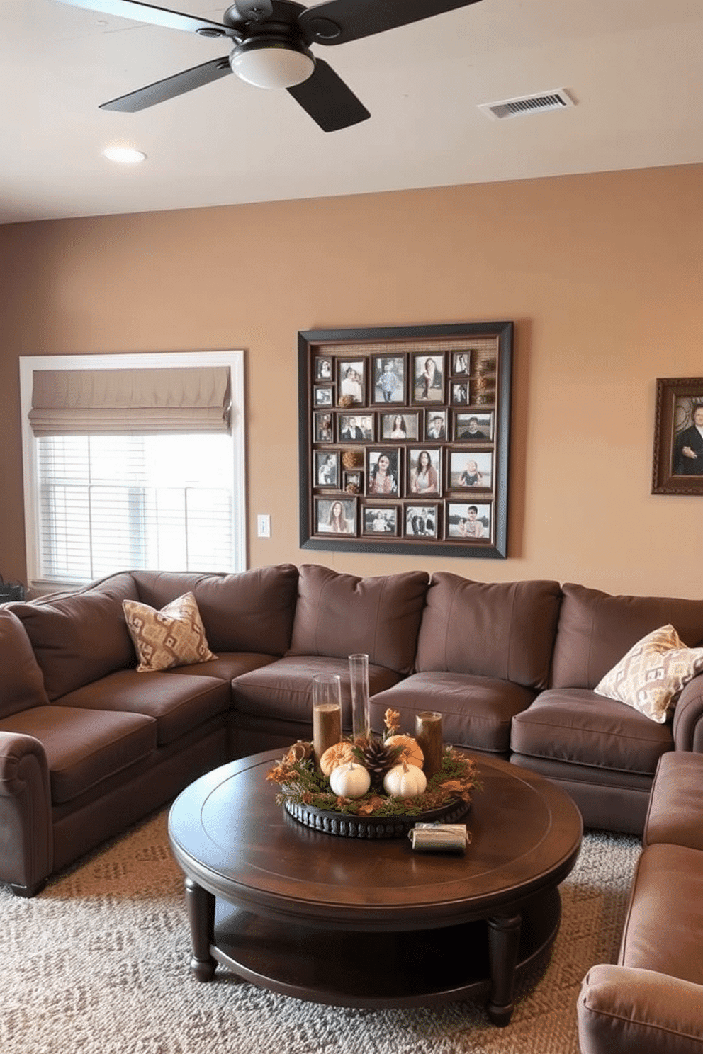 A cozy game room featuring a family photo collage displayed in rustic fall-themed frames. The walls are painted in warm earth tones, and a plush sectional sofa is arranged around a wooden coffee table, adorned with seasonal decorations.