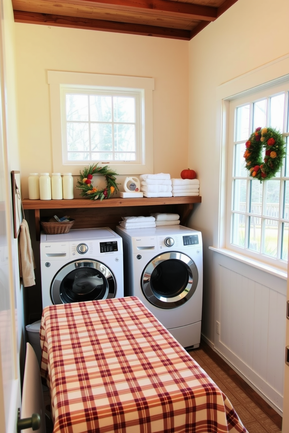 A cozy laundry room with a folding area adorned with a plaid tablecloth. The walls are painted in a soft cream color, and a rustic wooden shelf displays neatly folded towels and laundry supplies. A large window allows natural light to flood the space, enhancing the warm ambiance. Decorative elements like a seasonal wreath and a small basket of fresh flowers add a festive touch for Thanksgiving.