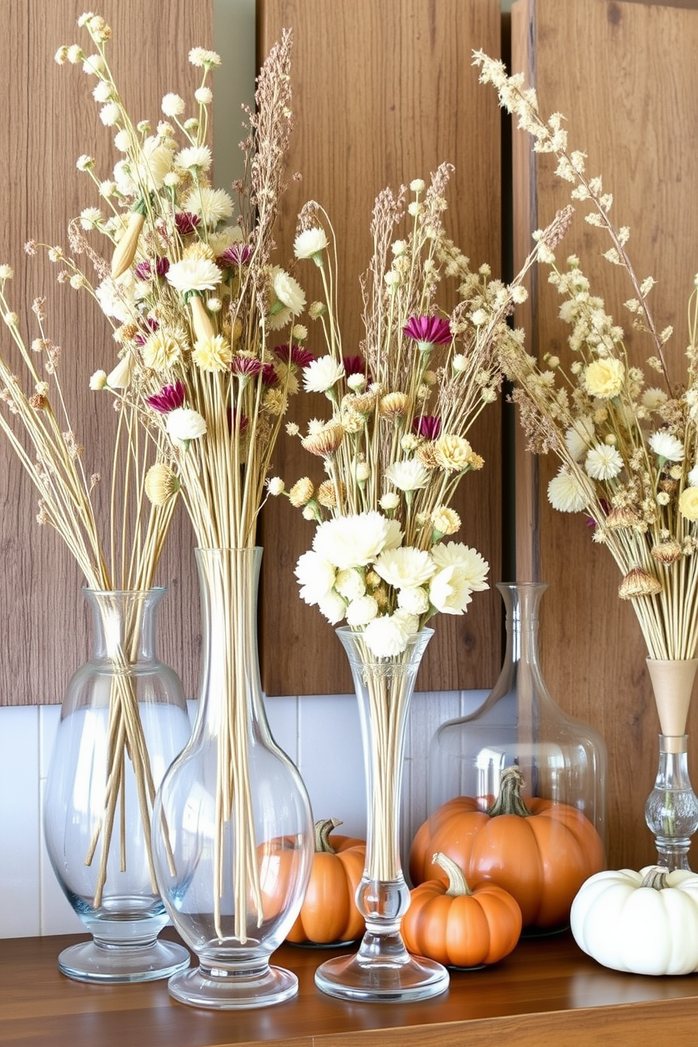 Create a warm and inviting Thanksgiving mantel adorned with an assortment of dried flowers in elegant glass vases. The vases vary in height and shape, showcasing the natural textures and colors of the dried blooms against a backdrop of rustic wooden accents.