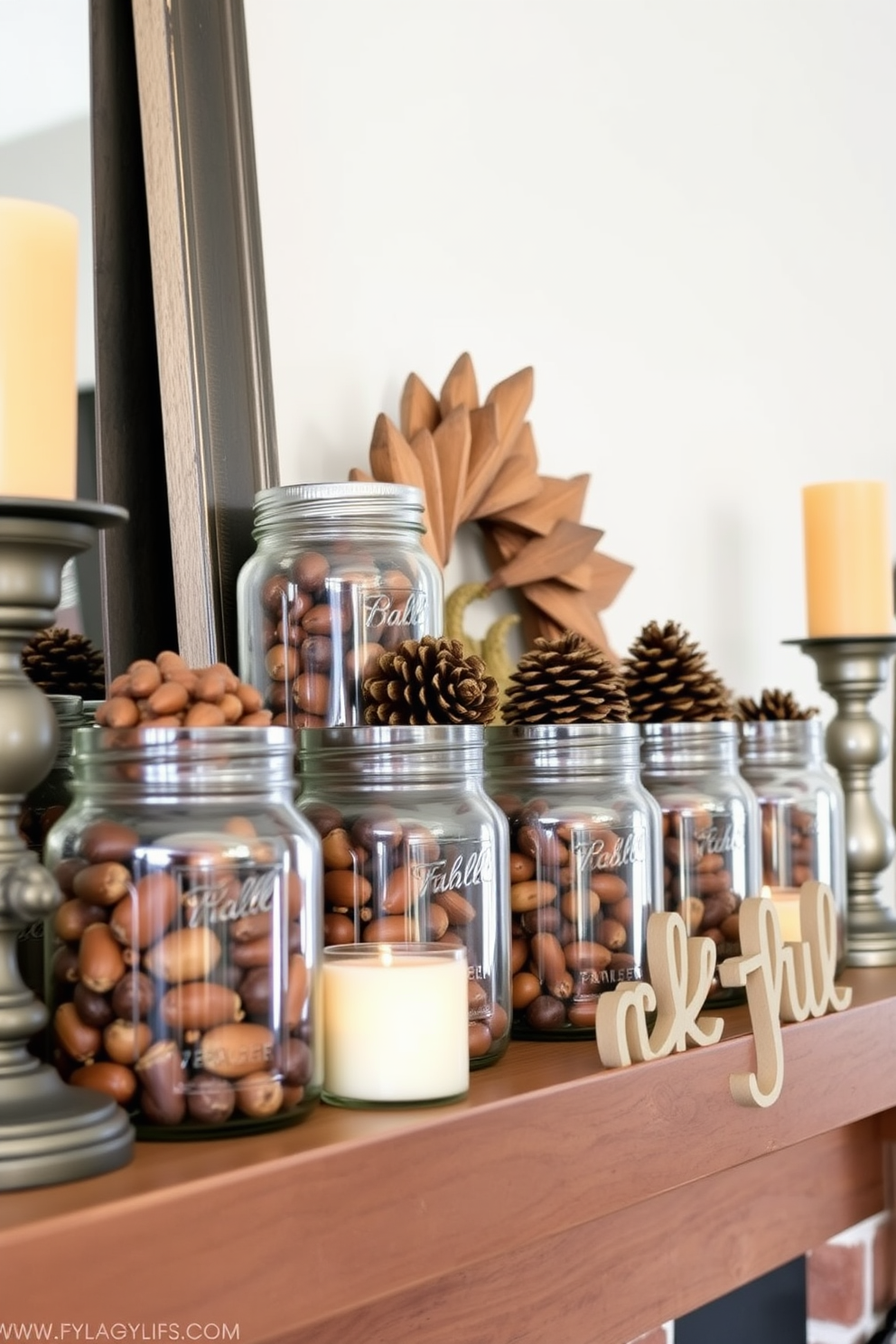 A cozy Thanksgiving mantel adorned with glass jars filled with acorns and pinecones. The jars are arranged in a staggered formation, complemented by warm-toned candles and a rustic wooden sign that reads thankful.