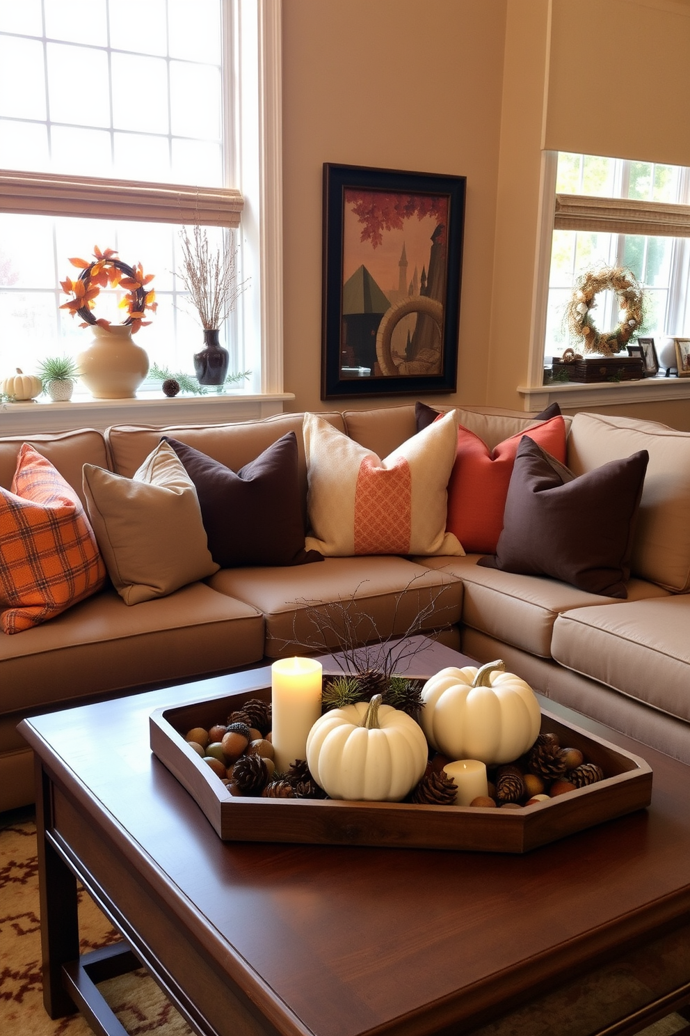 A cozy living room adorned with seasonal decor on the window sills. Soft throw pillows in autumn hues complement a small, elegant pumpkin centerpiece nestled among candles. The walls are painted in a warm beige tone, creating an inviting atmosphere. A compact coffee table holds a decorative tray with pinecones and acorns, enhancing the Thanksgiving theme.