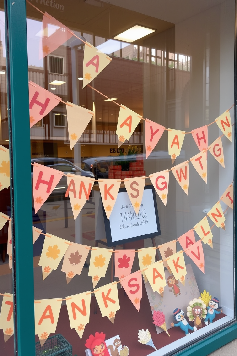 A festive window display featuring colorful bunting adorned with Thanksgiving messages. The bunting is strung across the window, creating a cheerful atmosphere with autumn-themed colors and playful designs.