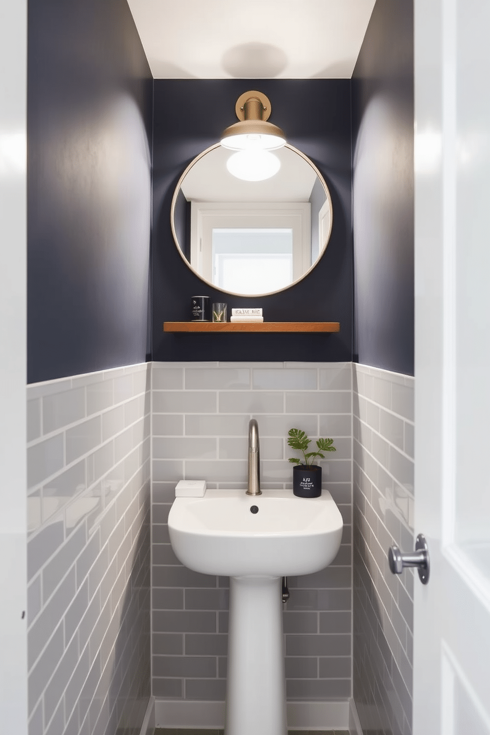 A compact corner sink solution features a sleek, wall-mounted sink with a minimalist design, set against a backdrop of light gray tiles. Above the sink, a small round mirror with a brushed nickel frame reflects the soft, ambient lighting from a stylish sconce. In a tiny powder room, a bold color palette of deep navy and crisp white creates a striking contrast. A floating shelf above the sink displays decorative items, while a small potted plant adds a touch of greenery to the space.