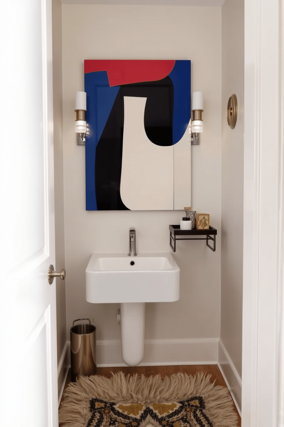 A tiny powder room features a bold, oversized art piece that serves as the focal point, drawing the eye and adding personality to the compact space. The walls are painted in a soft, neutral color to enhance the room's brightness, while a sleek, wall-mounted sink maximizes floor space. To complement the art, elegant sconces frame the mirror, providing warm lighting that highlights the artwork and creates a welcoming atmosphere. A small, stylish shelf holds decorative items, and a plush, patterned rug adds texture and comfort underfoot.