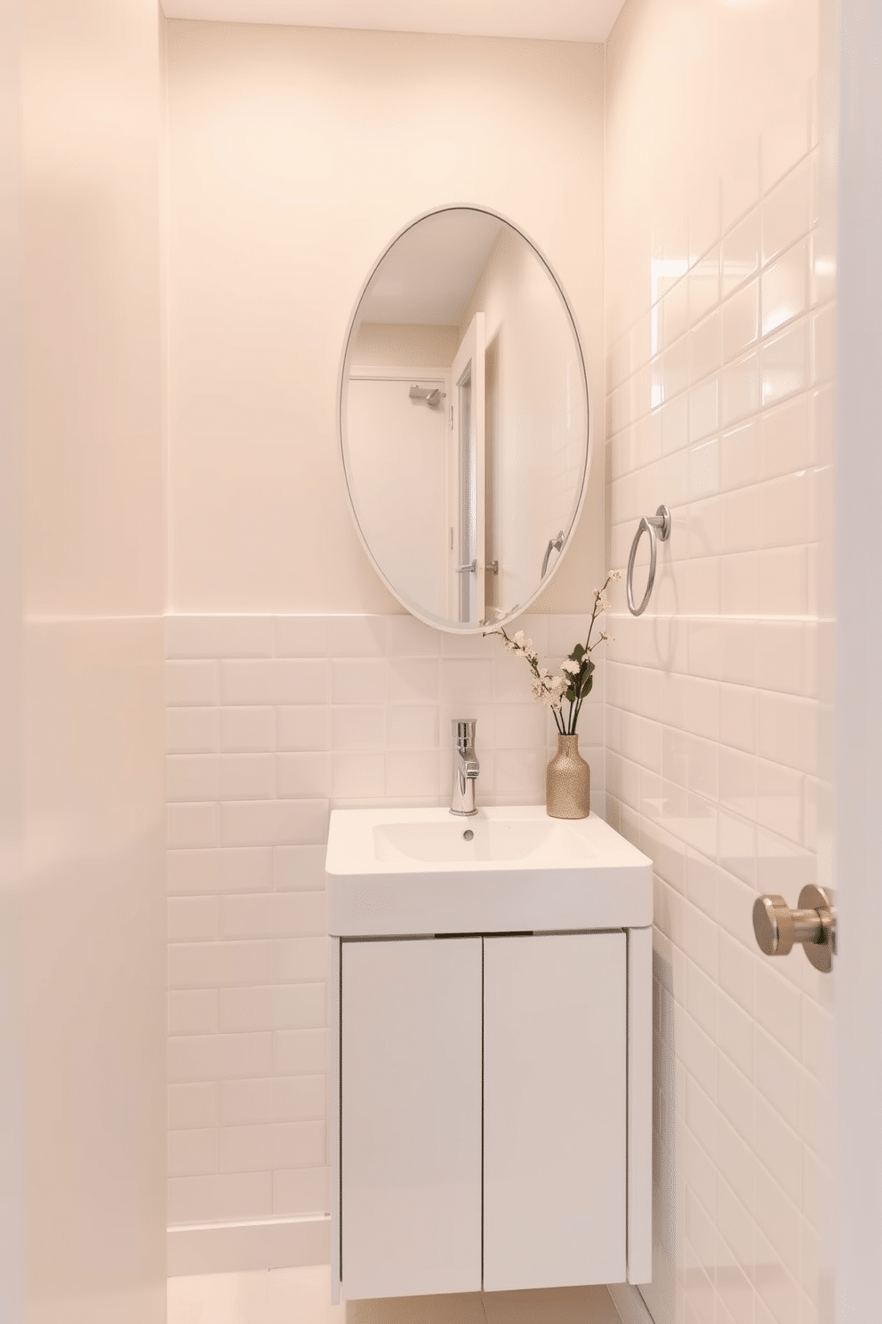 A tiny powder room featuring light-colored tiles that enhance the airy feel of the space. The walls are adorned with soft, pastel accents, and a sleek, modern sink is mounted above a minimalist cabinet for optimal storage.