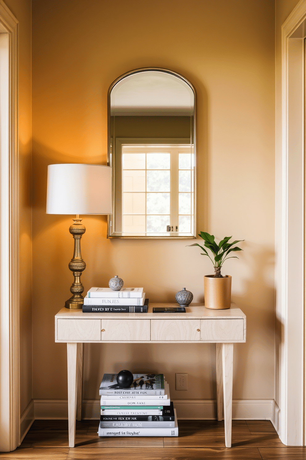 A narrow console table is positioned against the wall, adorned with an assortment of decorative items like a stylish lamp, a stack of art books, and a small potted plant. The entryway features a warm color palette, with a statement mirror above the table reflecting natural light and enhancing the space's openness.