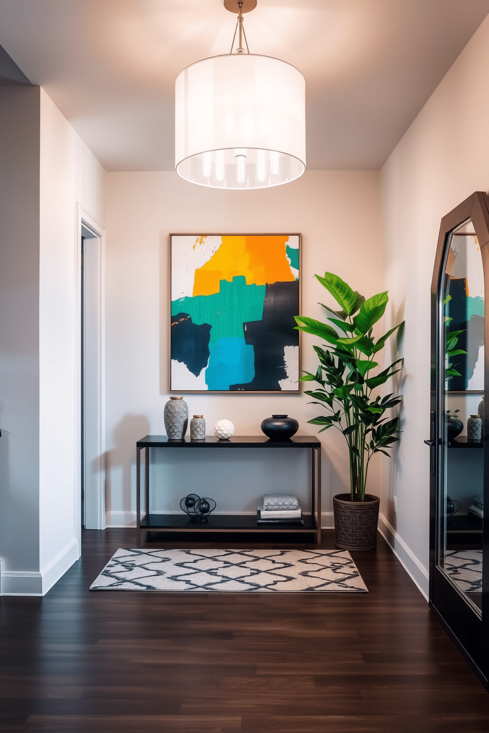 A striking entryway featuring bold artwork as the focal point, set against a backdrop of soft, neutral walls. The space is illuminated by a modern chandelier, and a sleek console table with decorative accents sits beneath the artwork. The floor is adorned with a geometric patterned rug, adding texture and warmth to the area. A tall potted plant in the corner enhances the inviting atmosphere, while a stylish mirror reflects the vibrant art piece, creating a sense of depth.