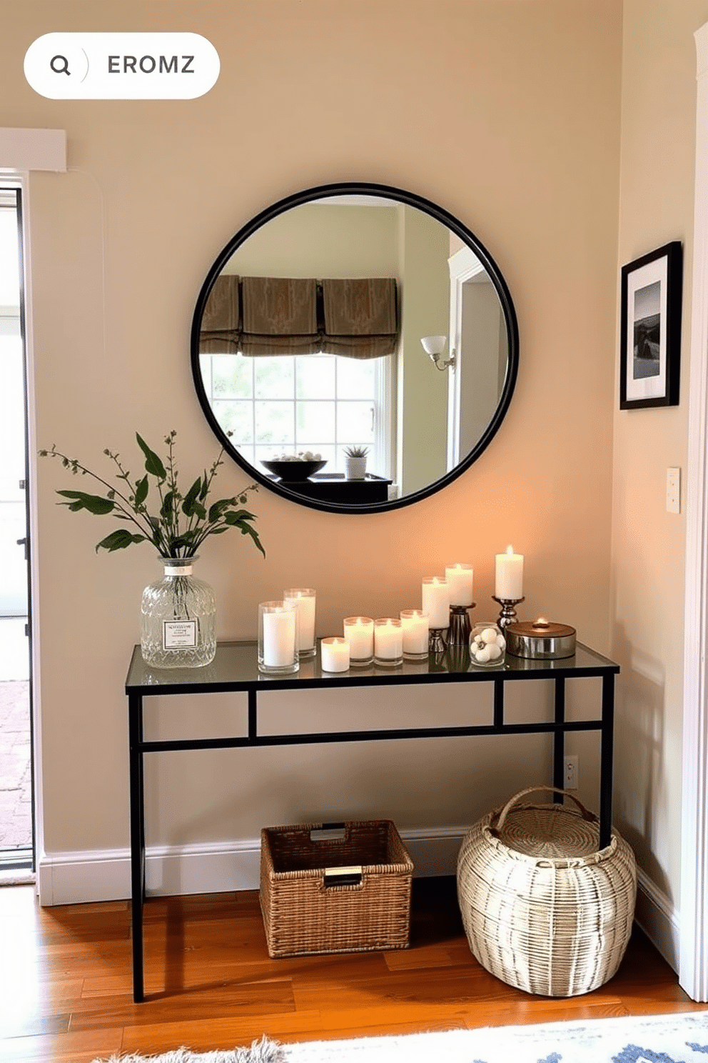 A cozy townhouse entryway featuring a stylish console table adorned with an array of scented candles and a chic diffuser. The walls are painted in a warm beige, complemented by a large round mirror that reflects natural light, creating an inviting atmosphere.