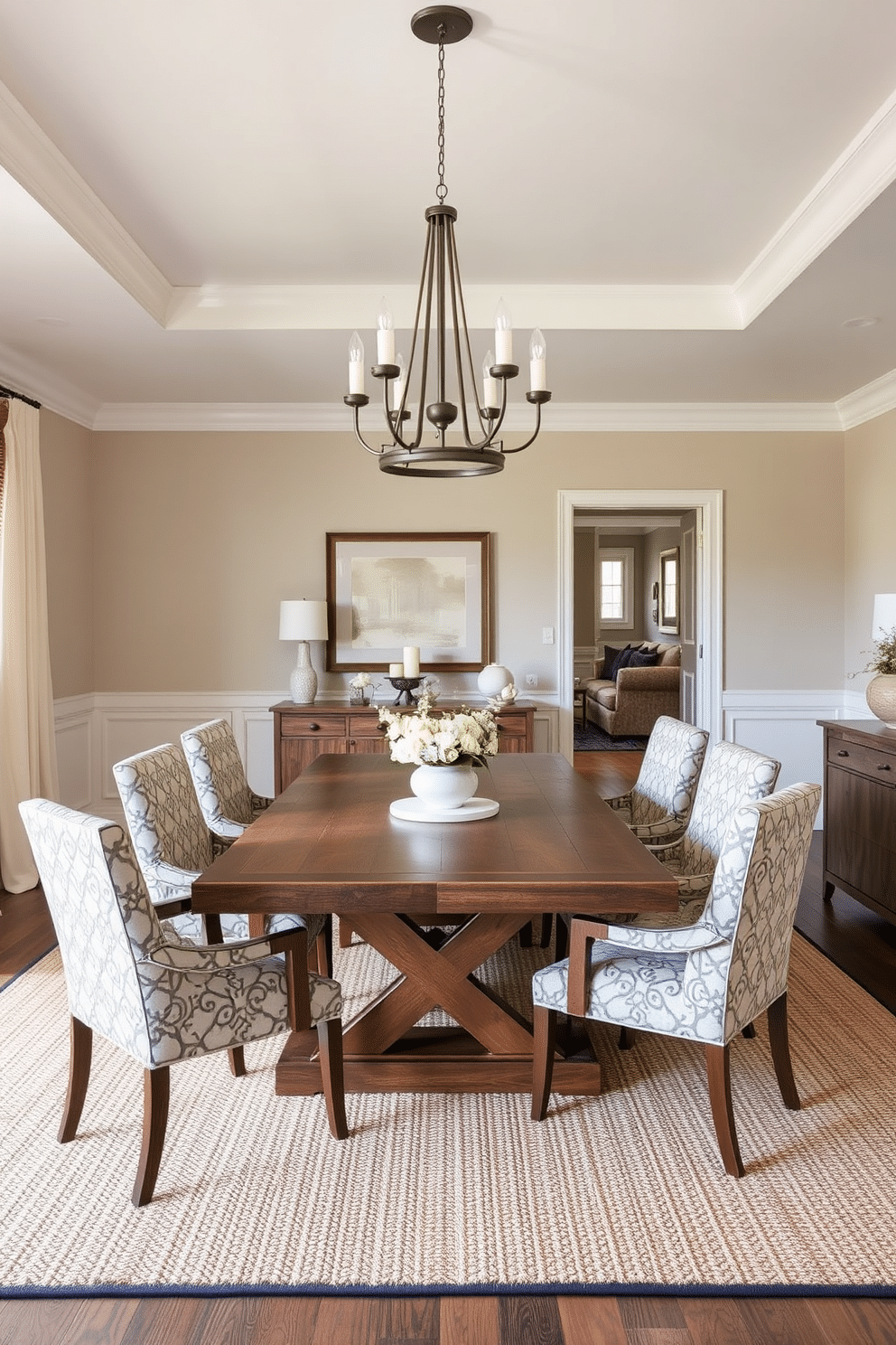 A transitional dining room featuring a blend of classic and modern furniture styles. A large wooden dining table with a rustic finish is surrounded by upholstered chairs in a contemporary pattern, creating a harmonious balance between old and new. The room is illuminated by a statement chandelier that combines traditional elements with a sleek, modern design. Soft, neutral wall colors complement the rich textures of a woven area rug that anchors the space, enhancing its inviting atmosphere.