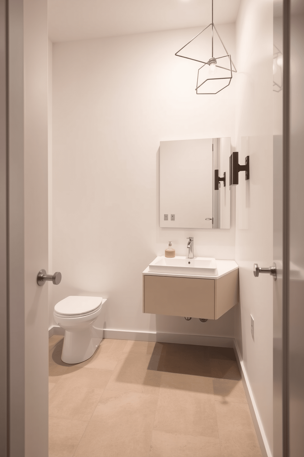 A trendy powder room featuring minimalist fixtures for a sleek look. The walls are painted in a soft, neutral tone, and the floor is adorned with large-format tiles in a subtle texture. A floating vanity with a single, streamlined sink sits beneath a large, frameless mirror. Stylish, geometric light fixtures provide warm illumination, enhancing the room's modern aesthetic.