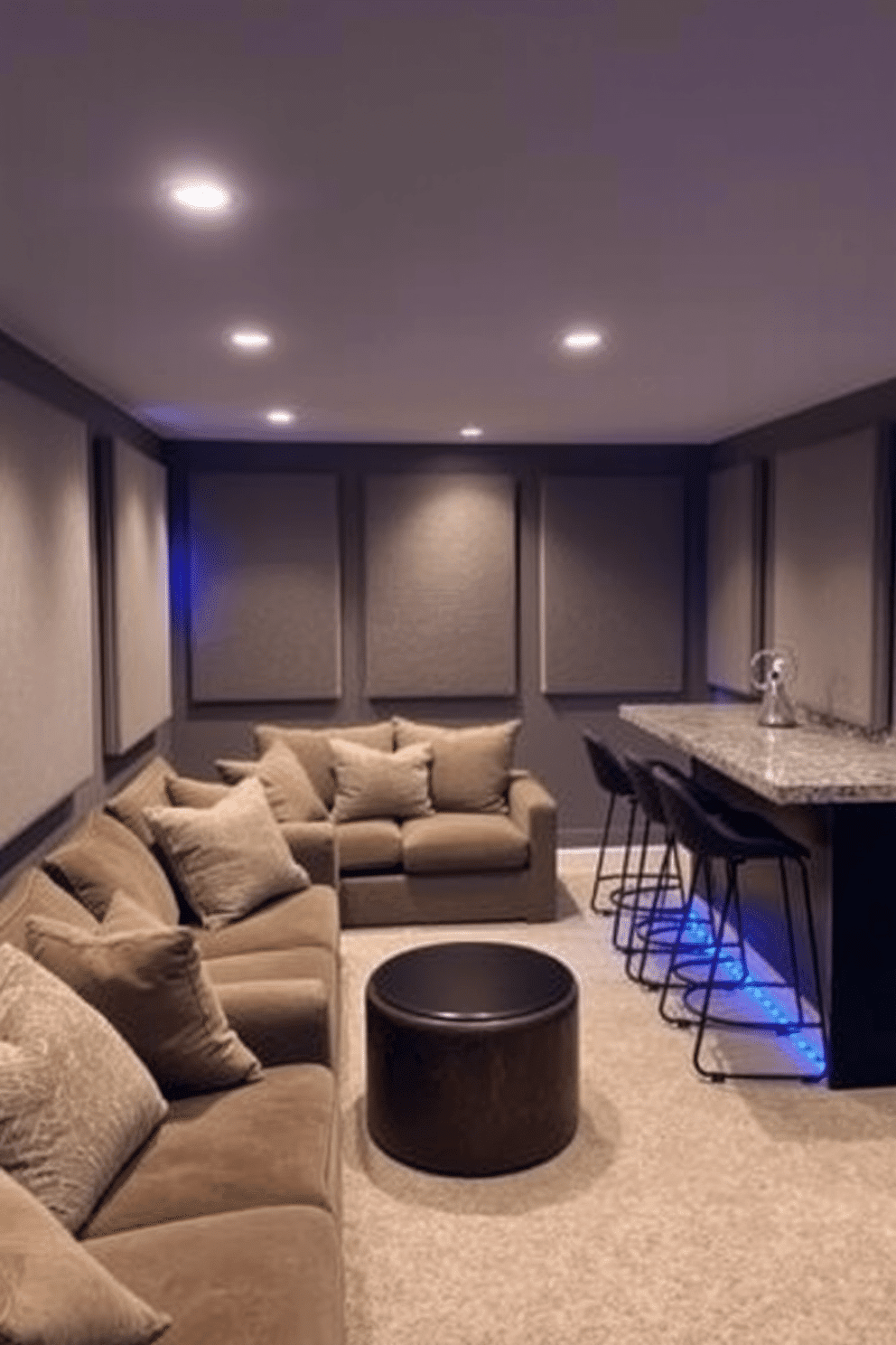 A cozy unfinished basement transformed into a serene retreat. The space features plush seating with soundproofing panels on the walls, ensuring quiet enjoyment. Soft ambient lighting illuminates the area, creating a warm atmosphere. A small bar with stylish stools is set against one wall, complementing the inviting decor.