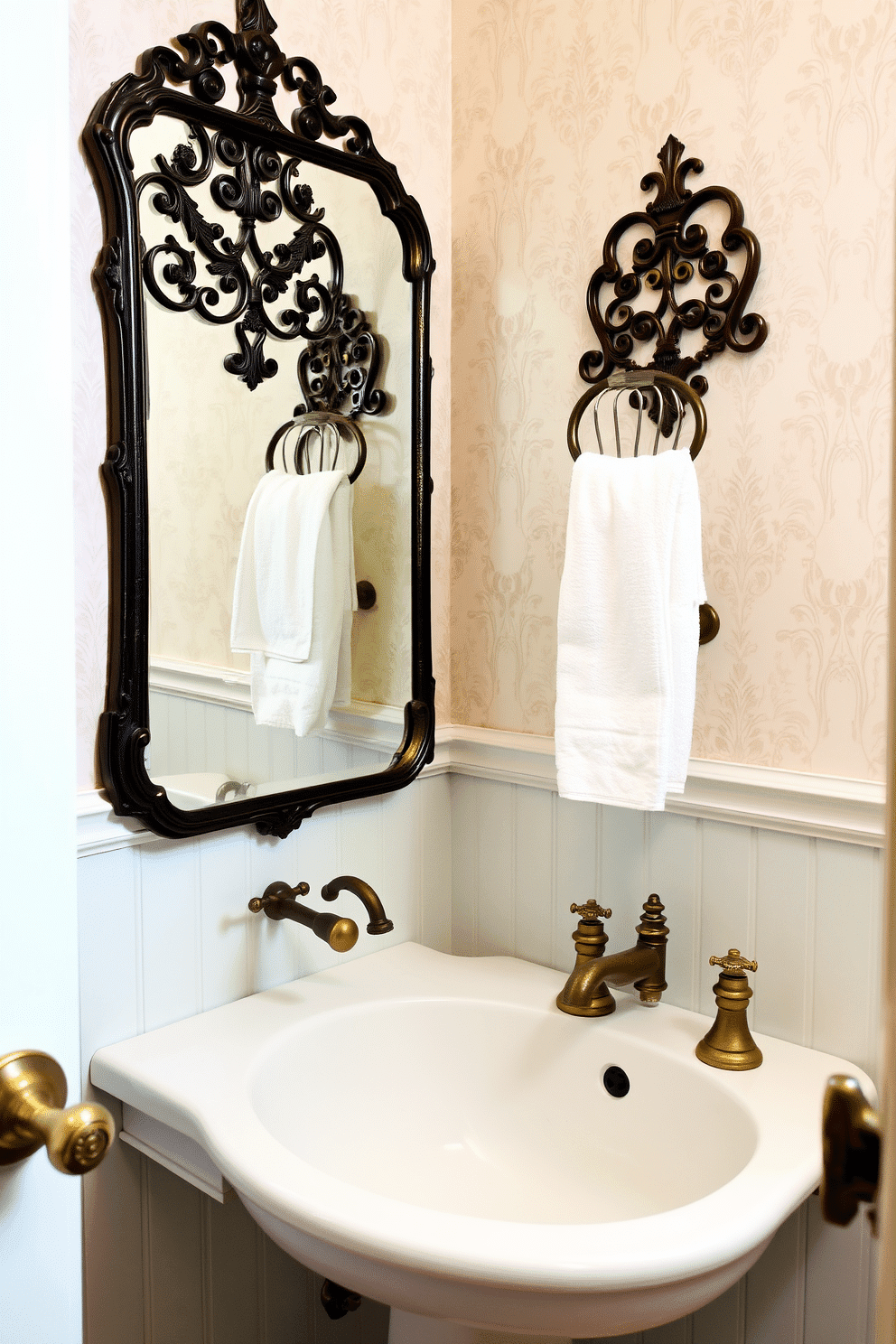 A vintage powder room featuring charming old-fashioned towel racks with intricate details. The space is adorned with soft pastel wallpaper and a classic pedestal sink, complemented by antique brass fixtures.