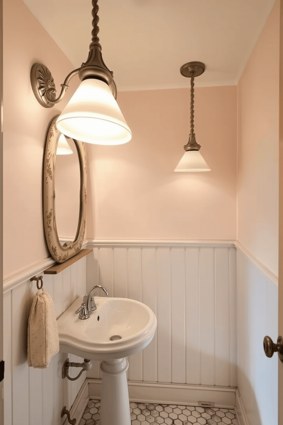 A vintage-inspired powder room features elegant light fixtures that exude a warm glow, creating an inviting atmosphere. The fixtures are adorned with intricate designs and soft, muted colors, perfectly complementing the room's overall aesthetic. The powder room showcases vintage elements such as a pedestal sink with classic chrome fixtures and a distressed wooden mirror. The walls are painted in a soft pastel hue, while the floor is covered with charming hexagonal tiles, enhancing the room's nostalgic charm.