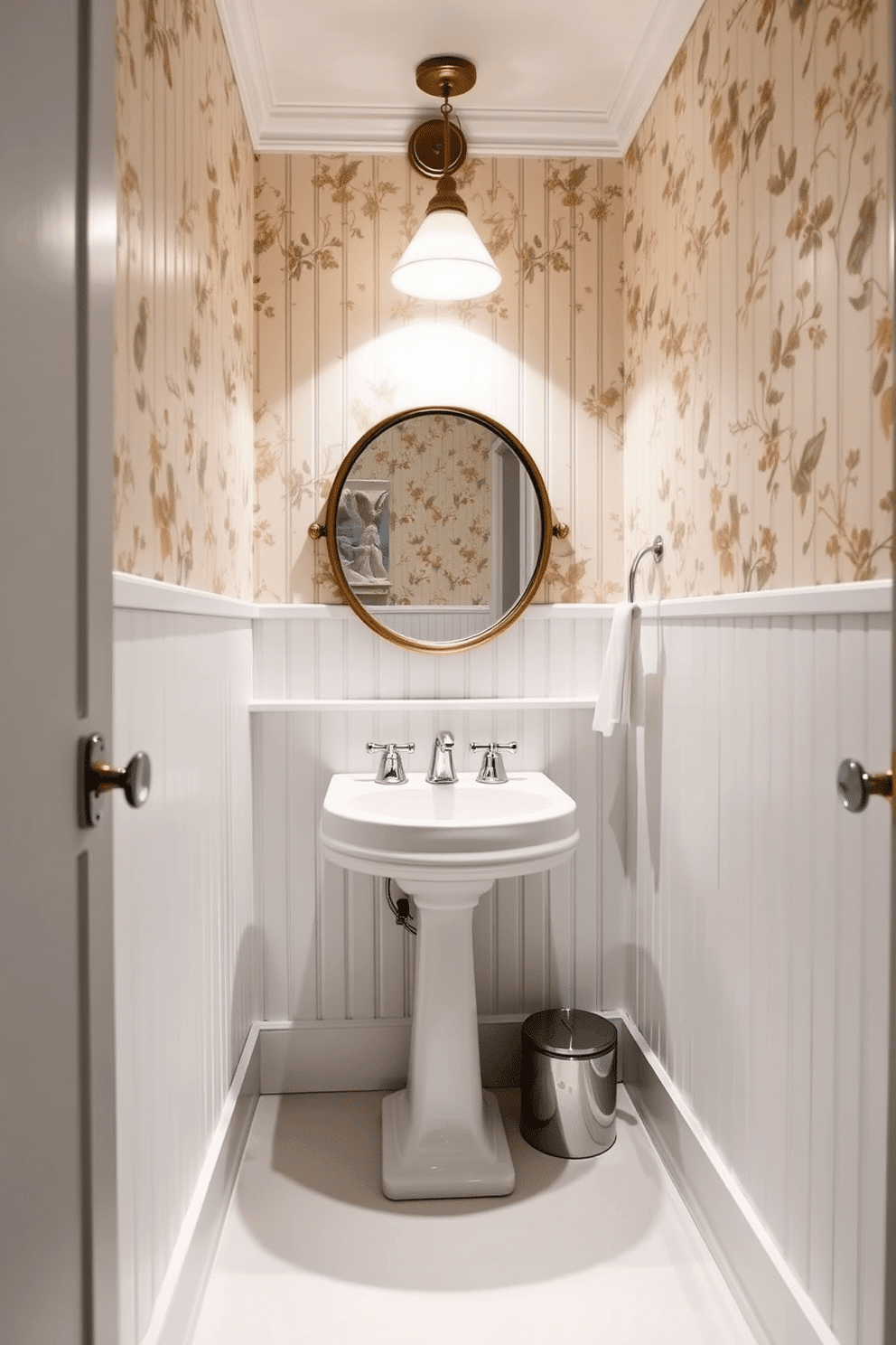 A vintage powder room featuring classic white beadboard paneling that extends from floor to ceiling. The space is accented with a stylish pedestal sink and a round mirror framed in antique brass, providing a touch of elegance. Soft, ambient lighting illuminates the room, highlighting the intricate details of the beadboard. A vintage-inspired wallpaper in muted floral tones adds warmth and character to the space, complemented by polished chrome fixtures.