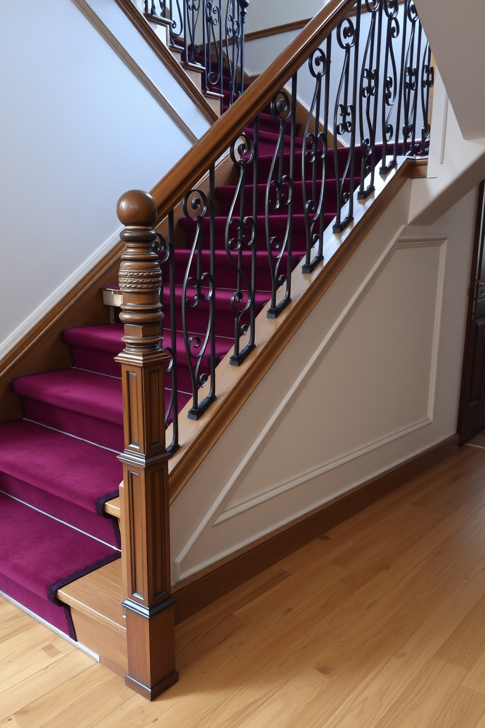 A vintage staircase with retro-inspired handrails, featuring intricate wrought iron details and a polished wooden banister. The stairs are carpeted in a rich, deep burgundy hue, contrasting beautifully with the light oak flooring below.