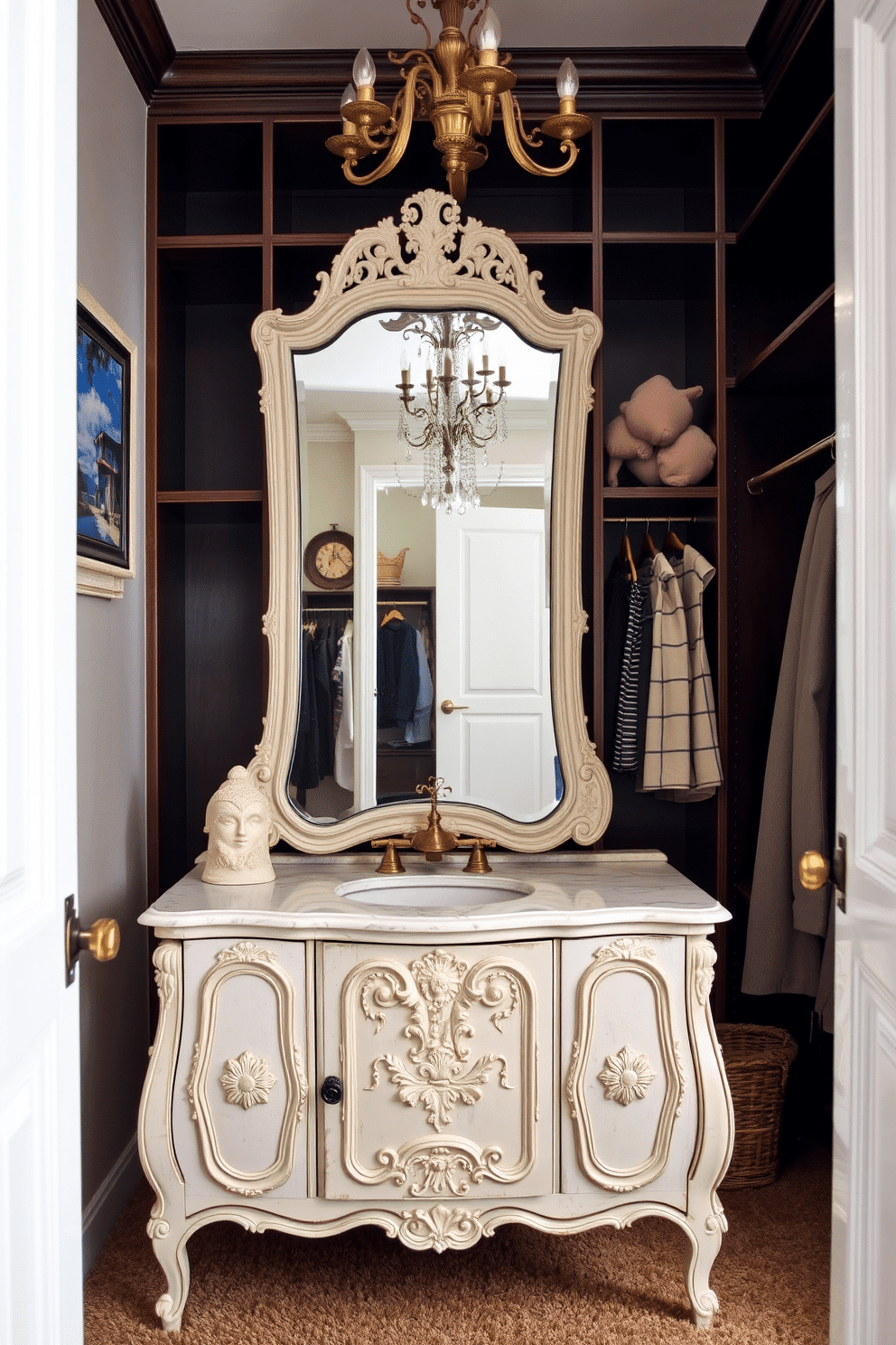 Charming vanity area with antique mirror. The vanity features a distressed white finish with ornate carvings and a marble top, complemented by a vintage-style brass faucet. Vintage walk-in closet design ideas. The space showcases dark wood shelving and hanging rods, with an elegant chandelier illuminating the room, while plush carpeting adds warmth underfoot.