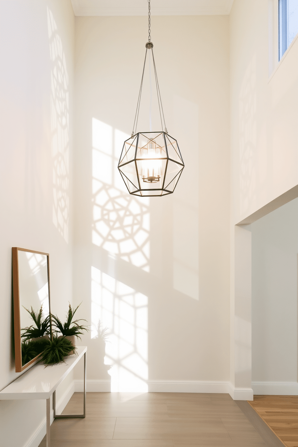 A bright and airy foyer features a stunning geometric pendant light fixture hanging from a high ceiling, casting intricate shadows on the walls. The space is adorned with a sleek console table against one wall, topped with a decorative mirror and fresh greenery, creating a welcoming entrance.