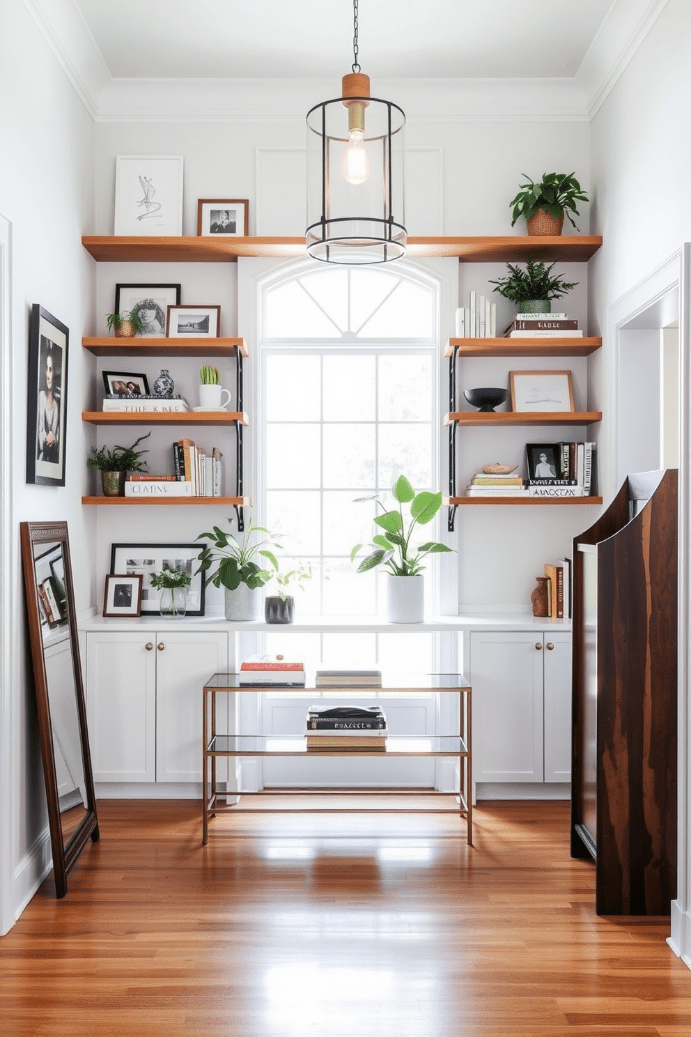 A bright and airy foyer features open shelving adorned with an eclectic mix of decorative accents, including framed photos, plants, and curated books. The walls are painted in a soft white, creating a clean backdrop that enhances the natural light flooding in through the large entryway window. The flooring consists of polished hardwood, adding warmth to the space, while a stylish console table sits beneath the shelving. A statement pendant light hangs from the ceiling, casting a welcoming glow over the foyer and highlighting the carefully arranged decor.