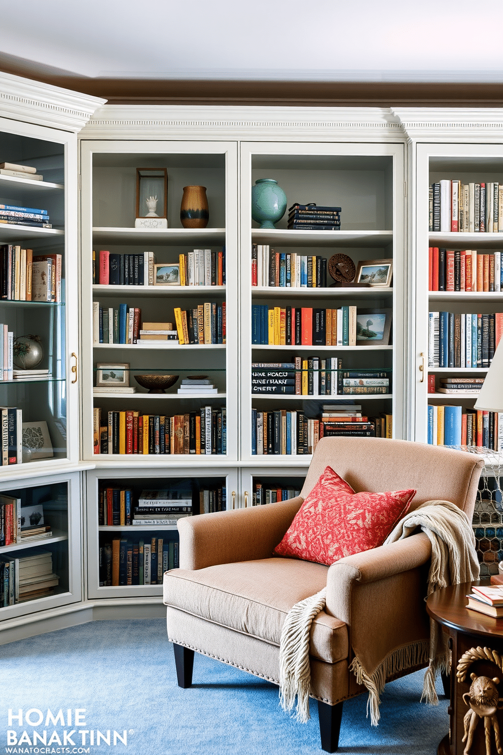 A bright and airy home library features glass-front cabinets lined with an array of colorful books and decorative objects. The room is accented with a plush reading nook, complete with a cozy armchair and a warm throw blanket, inviting relaxation and inspiration.