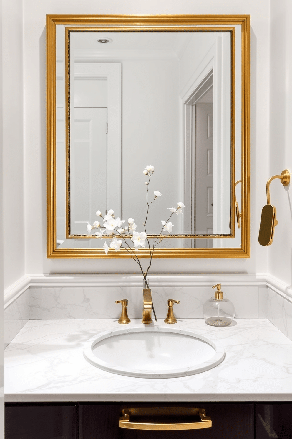 Elegant marble countertop with gold accents. The walls are painted in a soft white, creating a bright and airy atmosphere. A stylish gold-framed mirror hangs above the sink, reflecting the luxurious finishes. Delicate floral arrangements in a chic vase add a touch of sophistication to the space.