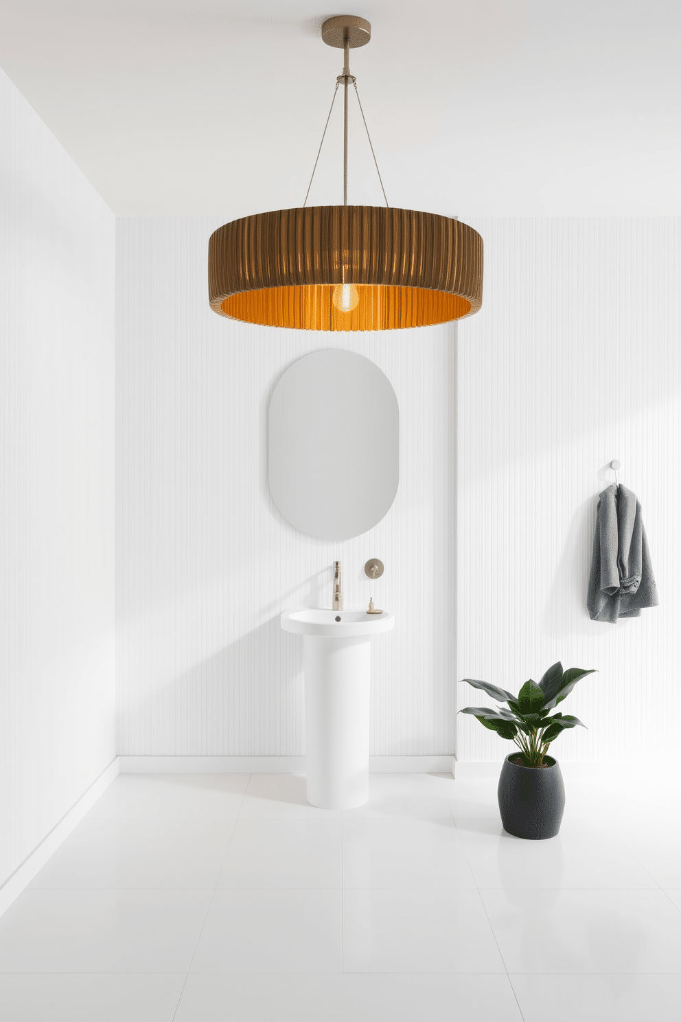 A striking statement light fixture hangs from the ceiling, casting a warm glow over the space. The walls are adorned with a crisp white wallpaper, while a sleek pedestal sink complements the minimalist aesthetic. The floor is covered in large format white tiles, creating a seamless look that enhances the room's elegance. A small potted plant adds a touch of greenery, bringing life to the refined atmosphere.