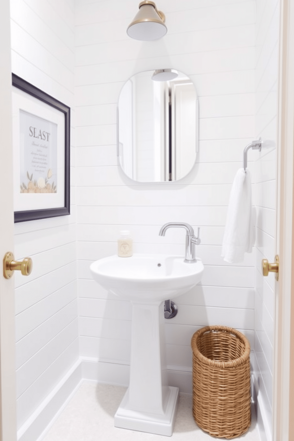 A bright white powder room features shiplap walls that evoke a refreshing coastal vibe. The space includes a sleek pedestal sink with a polished chrome faucet, complemented by nautical-themed decor such as a framed seashell print and a woven basket for storage.