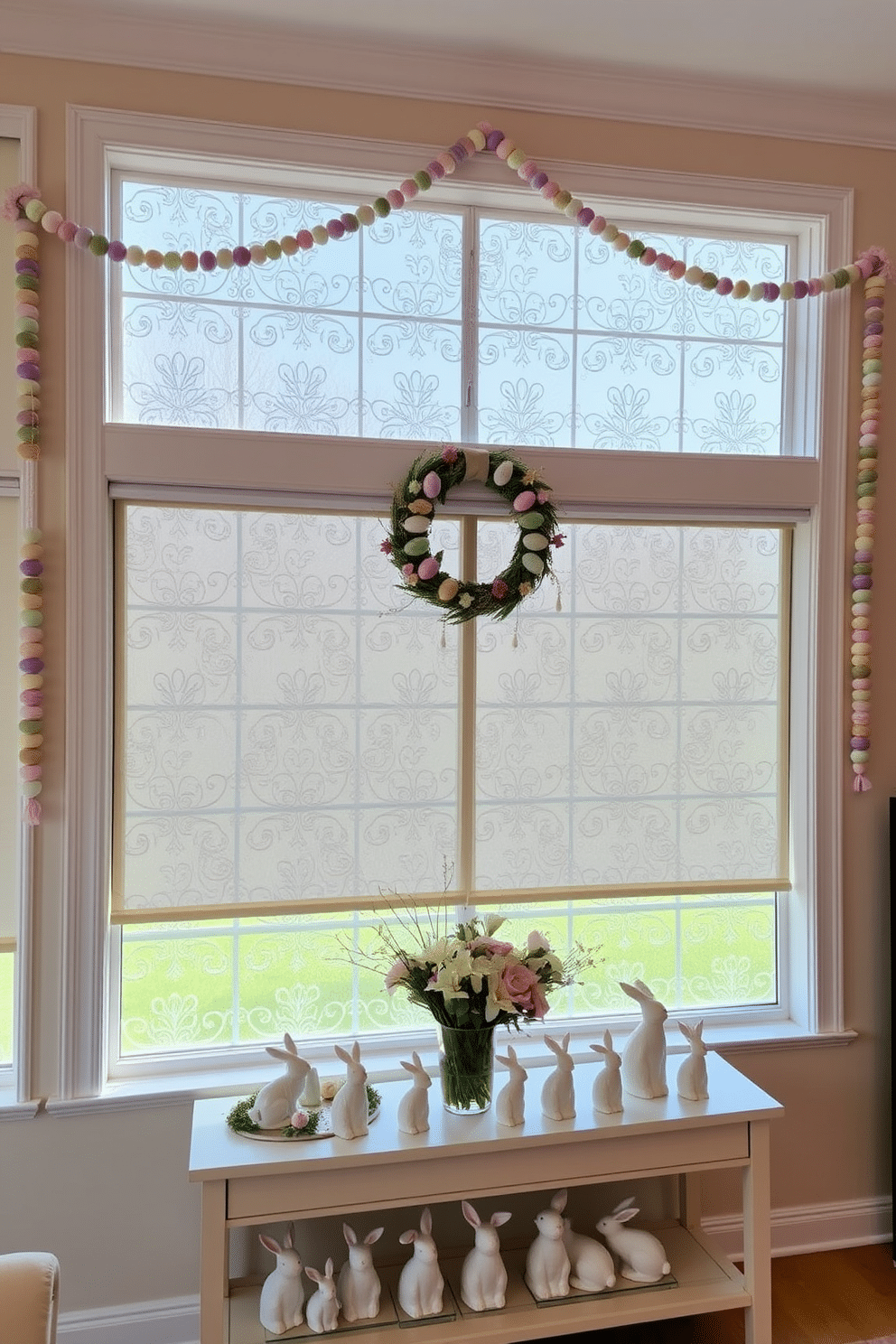 A large living room with a decorative window film featuring intricate floral patterns. The film covers the bottom half of the windows, allowing natural light to filter through while providing privacy. The room is decorated for Easter, with pastel-colored garlands hanging across the window frames and a wreath adorned with faux eggs and flowers centered on the main window. Below the window, a console table holds a collection of porcelain bunnies and a vase filled with fresh spring flowers.