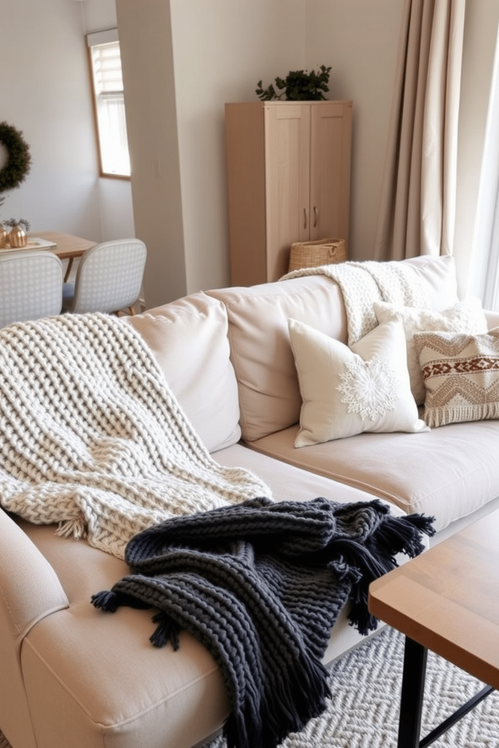 Cozy knit throw blankets are draped over plush sofas in a warm and inviting winter apartment. Soft neutral colors enhance the comfort of the space, while decorative pillows add a touch of seasonal charm.