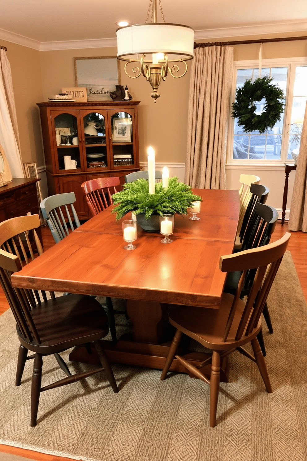 A charming winter dining room features a rustic wooden table surrounded by an eclectic mix of dining chairs in various styles and colors. Soft, warm lighting creates an inviting atmosphere, while a centerpiece of pine branches and candles adds a seasonal touch.