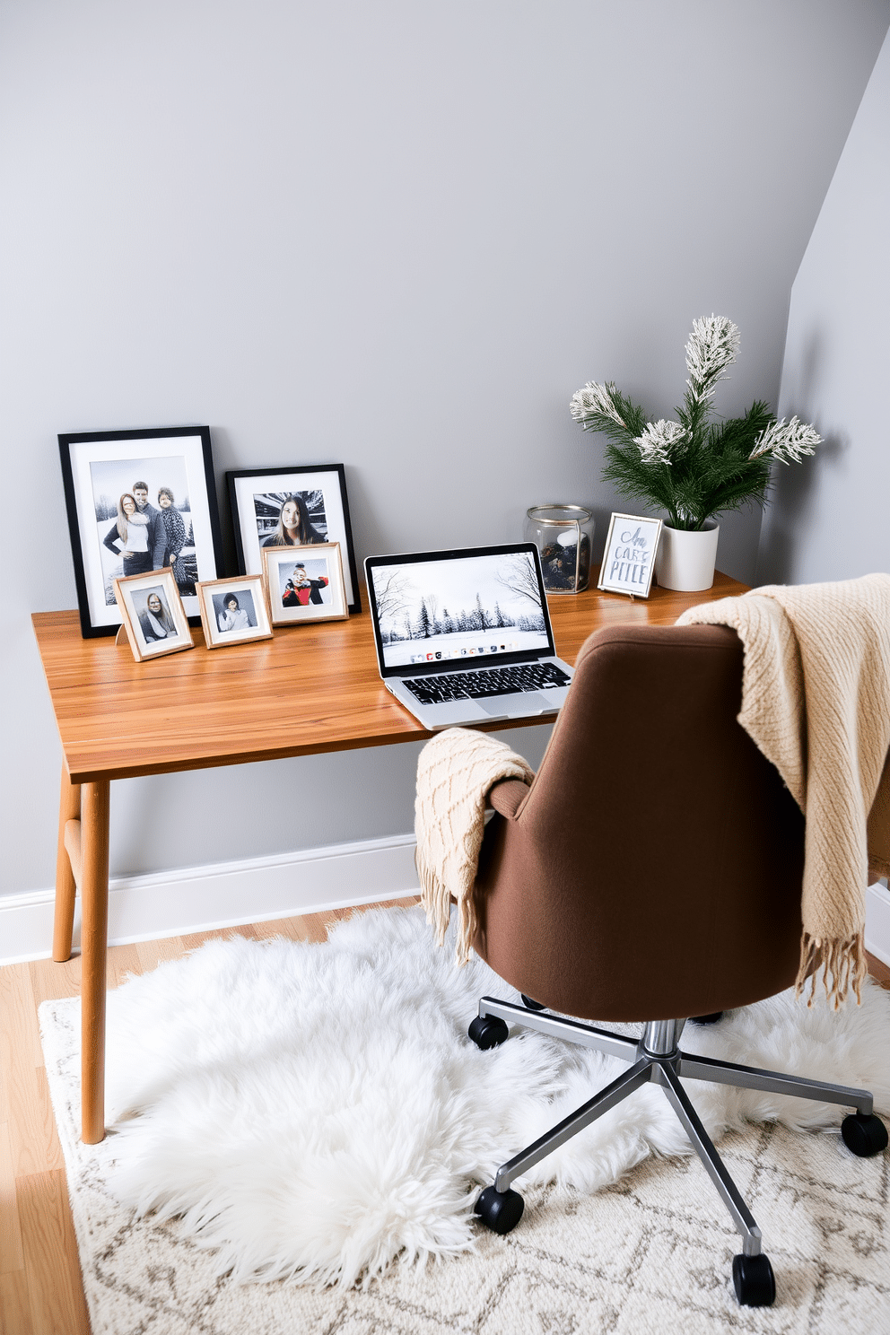 A cozy winter home office setting. There are personalized photo frames displaying winter memories arranged on the desk next to a stylish laptop. The walls are painted in a soft gray hue, creating a calm atmosphere. A plush area rug lies beneath the desk, while a comfortable chair with a warm throw blanket invites productivity.