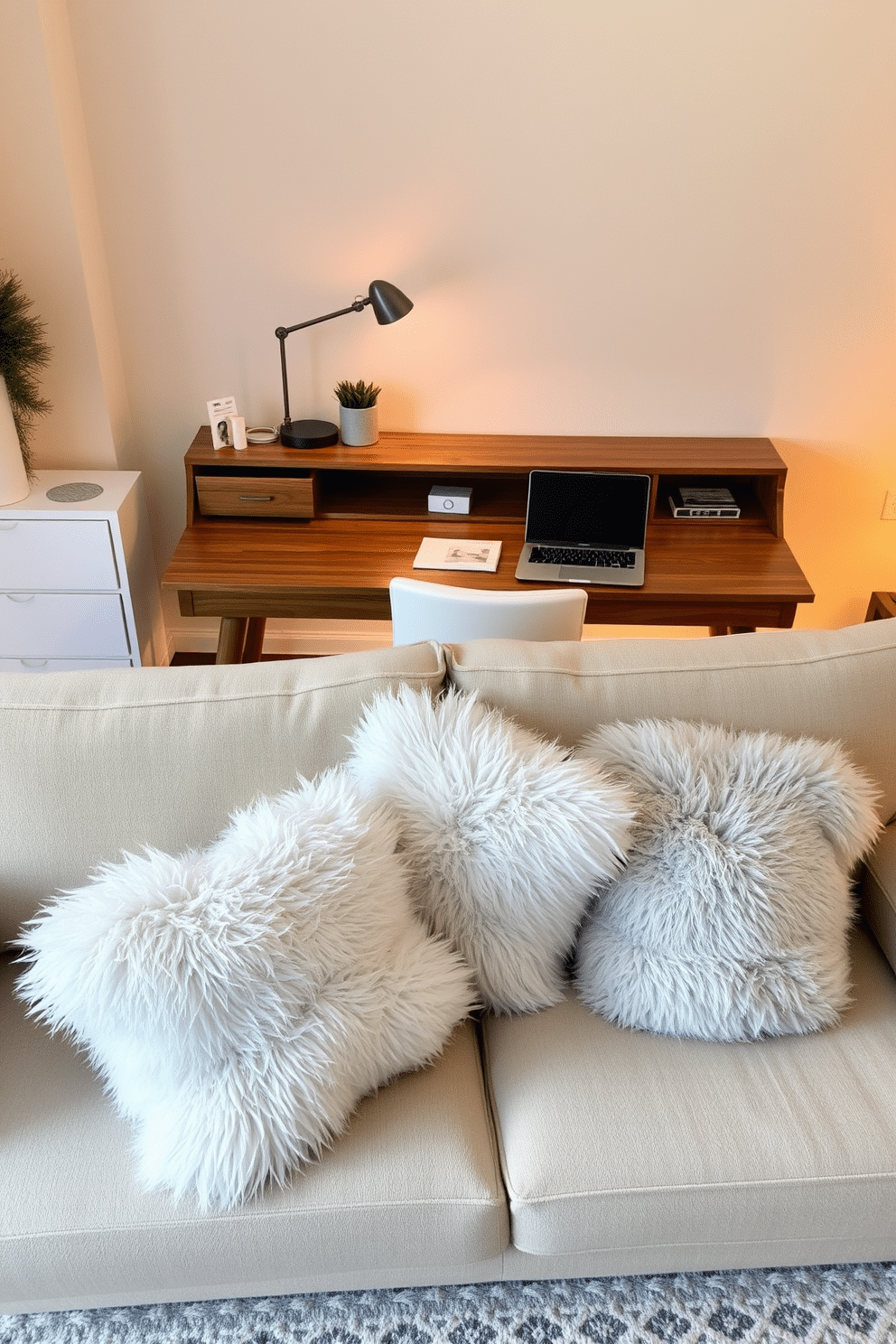 A cozy winter home office setting. The space features a large wooden desk with a sleek laptop and a stylish desk lamp, surrounded by warm lighting. On the sofa, there are plush faux fur throw pillows in soft shades of white and gray, inviting relaxation. A soft area rug in neutral tones lies beneath the desk, enhancing the comfort of the room.