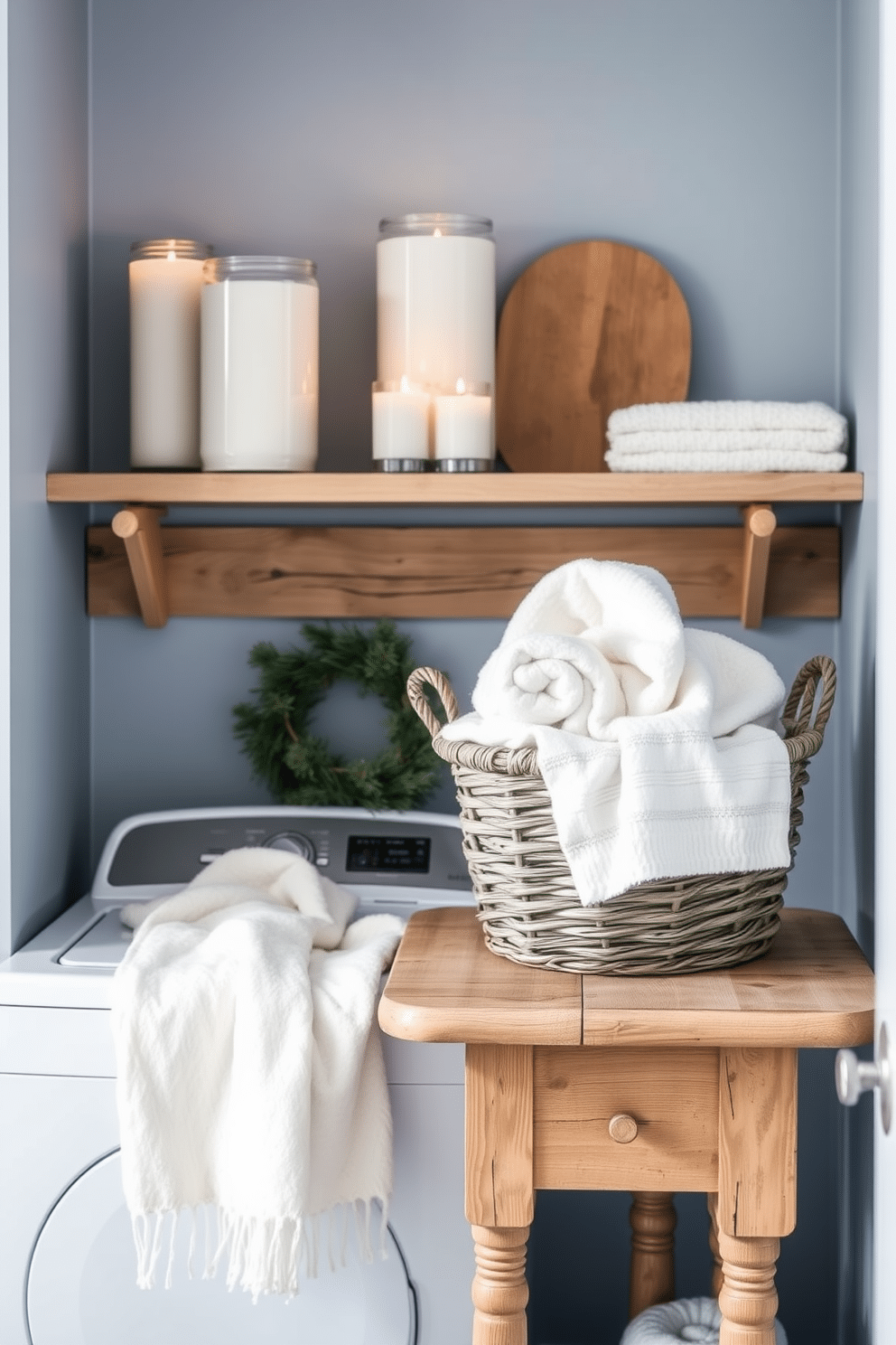 A cozy winter laundry room featuring winter-scented candles placed on a wooden shelf. The walls are painted in a soft blue hue, and a rustic wooden table is adorned with a fluffy white throw and a basket of freshly laundered towels.