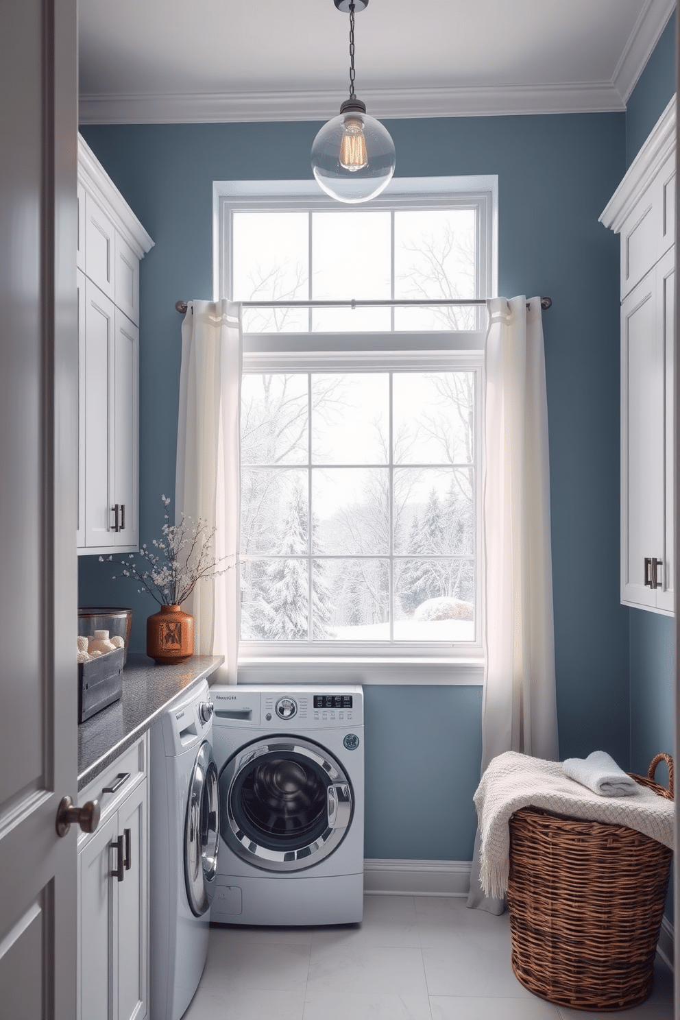 A serene laundry room inspired by winter landscapes. The walls are painted a soft blue, evoking the tranquility of a snowy day, with white cabinetry providing ample storage for supplies. A large window allows natural light to flood the space, framed by sheer white curtains that flutter gently. Decorative elements include artwork of snowy trees and a cozy throw placed on a wicker basket for warmth and comfort.