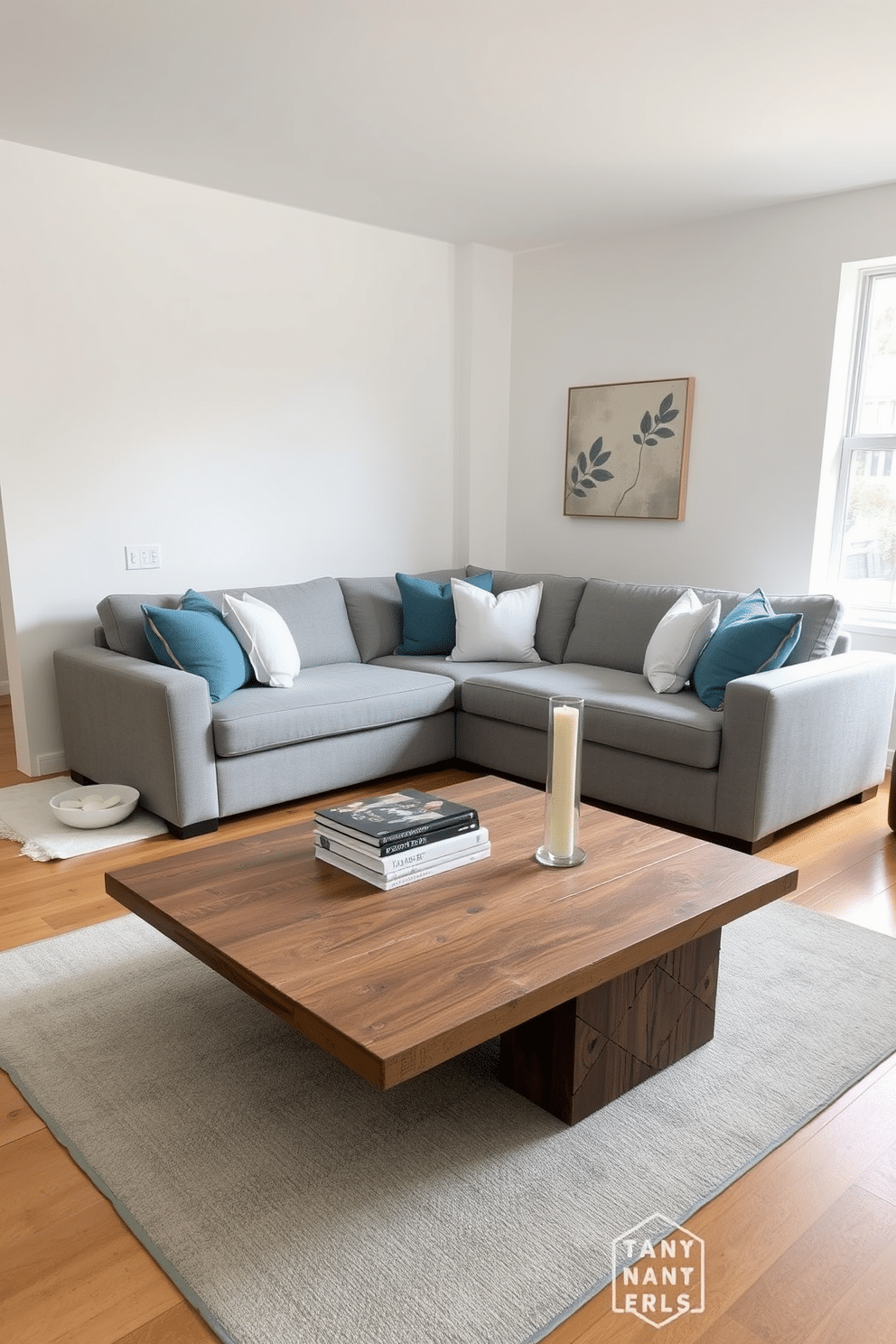 A large inviting sectional sofa is positioned in the center of the room, upholstered in a soft gray fabric that complements the warm wooden flooring. Surrounding the sofa are plush throw pillows in various shades of blue and white, adding a cozy touch to the space. A stylish coffee table made of reclaimed wood sits in front of the sofa, adorned with a stack of design books and a decorative candle. The walls are painted in a light, airy color, and a large window allows natural light to flood the room, enhancing the inviting atmosphere.