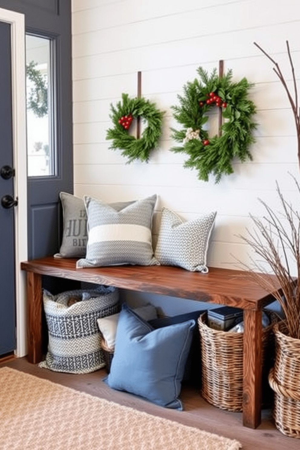 A charming winter mudroom features a rustic wooden bench adorned with cozy throw pillows in shades of blue and white. Seasonal wreaths made of evergreen branches and berries hang on the door, welcoming guests with a touch of festive cheer.