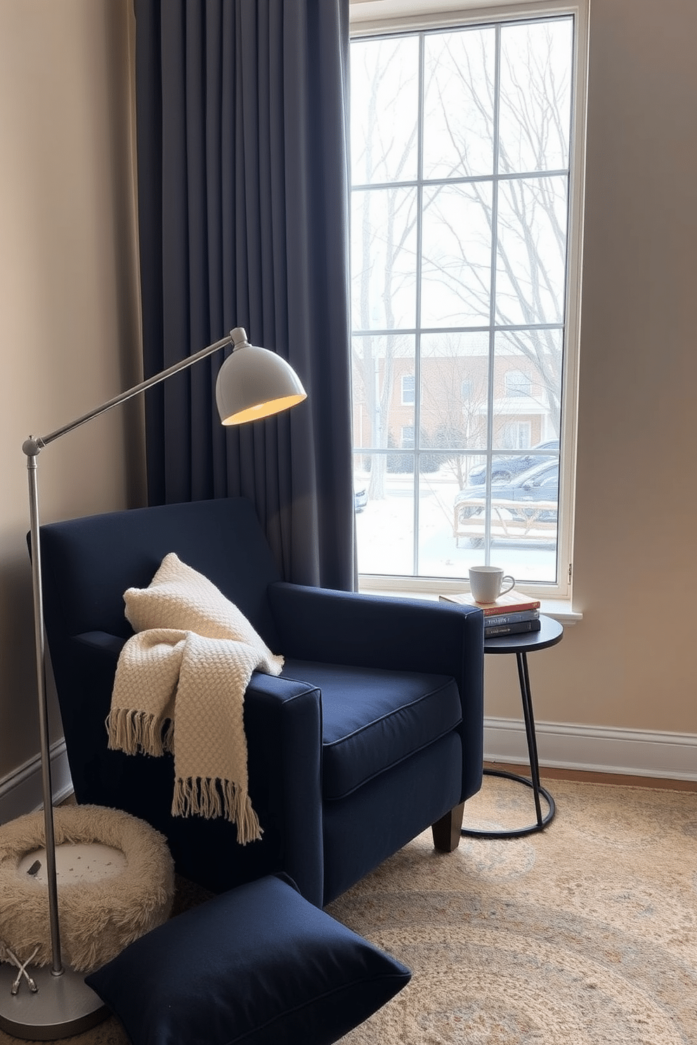 A cozy winter reading nook features a plush armchair in a deep navy blue fabric, perfectly positioned next to a large window that allows natural light to flood the space. A sleek reading lamp with adjustable brightness stands beside the chair, providing the ideal illumination for curling up with a good book on chilly evenings. The nook is accented with a soft throw blanket draped over the arm of the chair and a small side table holding a steaming cup of tea and a stack of books. The walls are painted in a warm cream color, and a soft area rug in muted tones anchors the space, adding warmth and comfort.