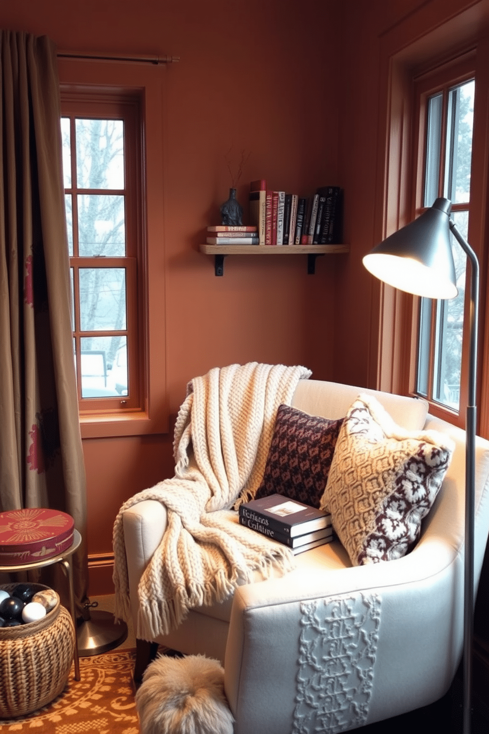 A cozy winter reading nook featuring warm-toned paint that envelops the space in a soft glow. A plush armchair is positioned near a window, adorned with a thick knit blanket and a stack of books on a small side table. A floor lamp with a warm light casts a gentle illumination, creating an inviting atmosphere. Decorative pillows in rich textures add comfort, while a small shelf displays cherished reads and personal mementos.