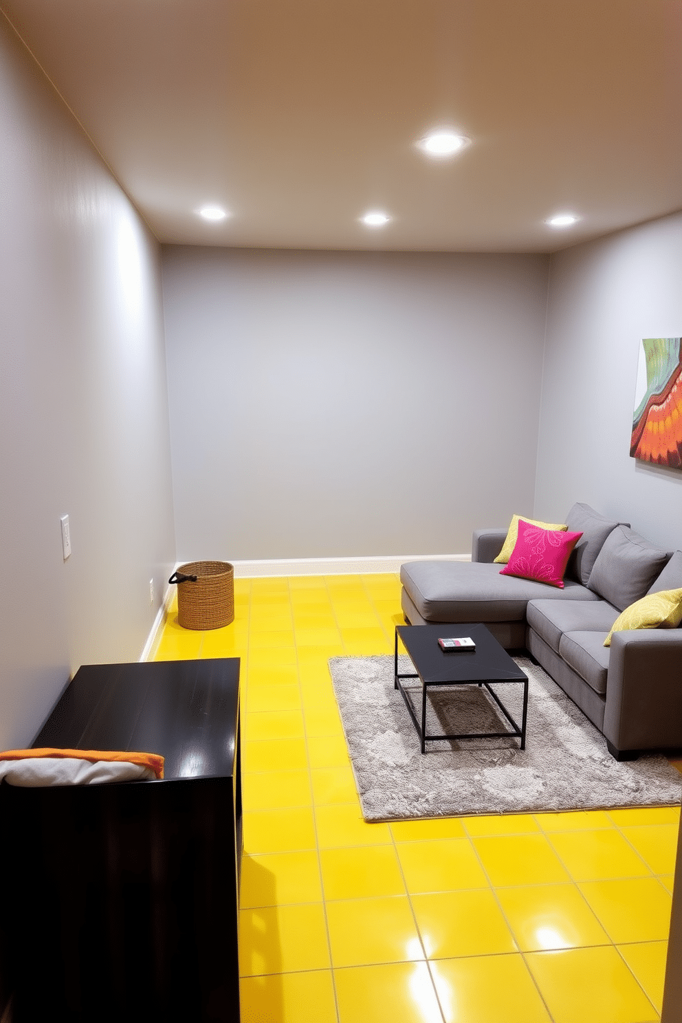 A cozy basement retreat featuring yellow ceramic tiles that brighten the space. The walls are painted in a soft gray, creating a warm contrast with the vibrant flooring. In one corner, a plush sectional sofa invites relaxation, adorned with colorful throw pillows. A sleek coffee table sits atop a textured area rug, adding comfort and style to the room.