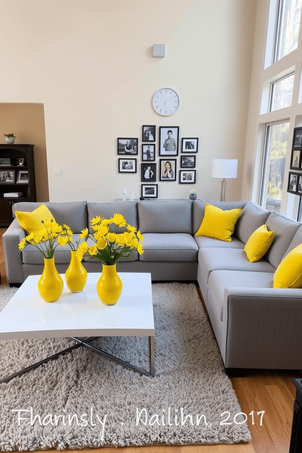 A bright and inviting family room features a cozy sectional sofa upholstered in soft gray fabric, accented with vibrant yellow throw pillows. On a sleek coffee table, bright yellow vases filled with fresh flowers add a cheerful pop of color, complementing the room's warm ambiance. The walls are painted in a soft cream hue, enhancing the natural light that floods in through large windows. A plush area rug in neutral tones anchors the space, while a gallery wall of family photos adds a personal touch to the decor.