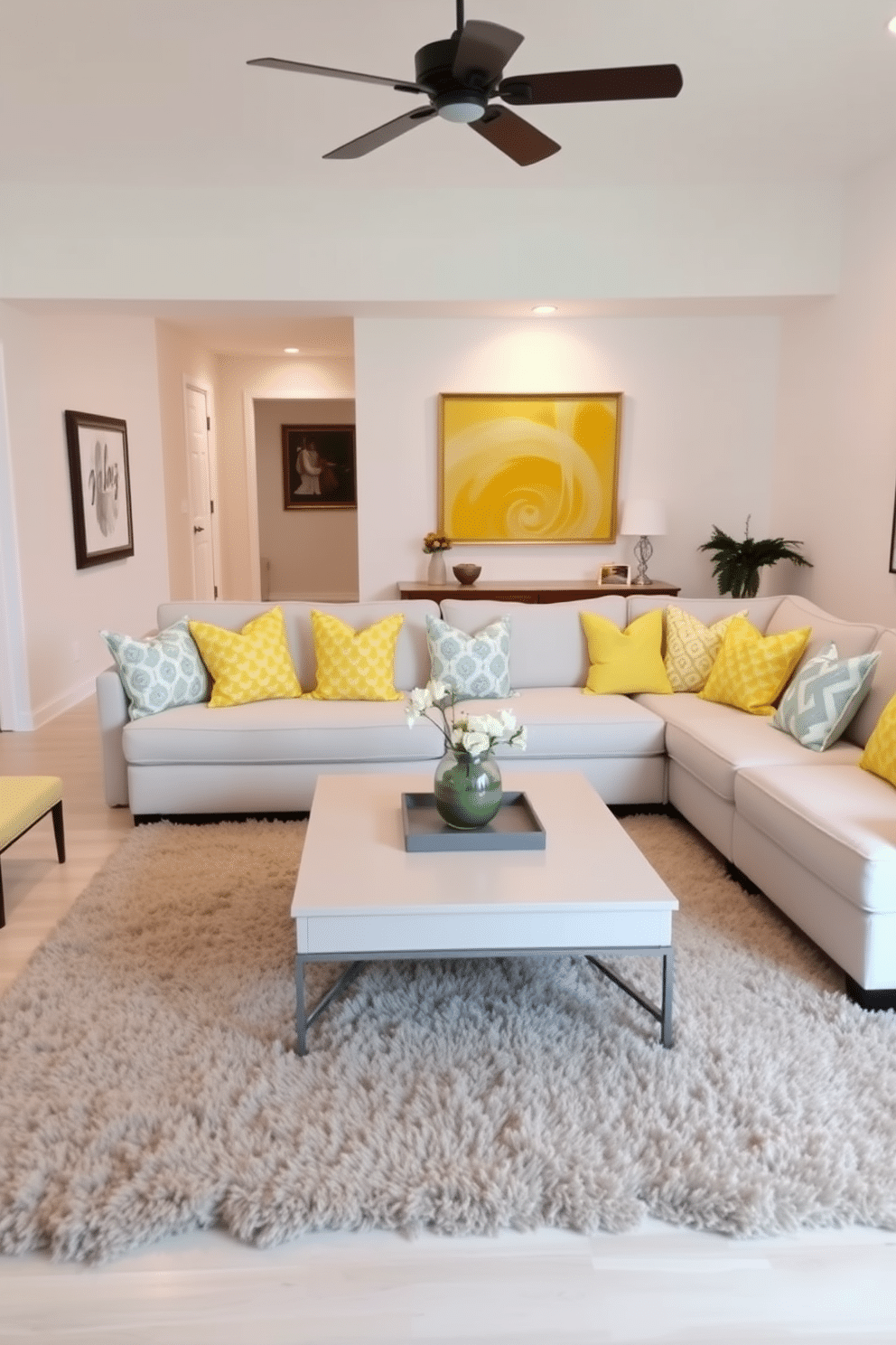 A bright and inviting family room features a large sectional sofa adorned with yellow cushions, each showcasing playful patterns that add a touch of whimsy. The walls are painted in a soft white, allowing the vibrant cushions to pop, while a stylish coffee table sits at the center, surrounded by a plush area rug that complements the cheerful theme.