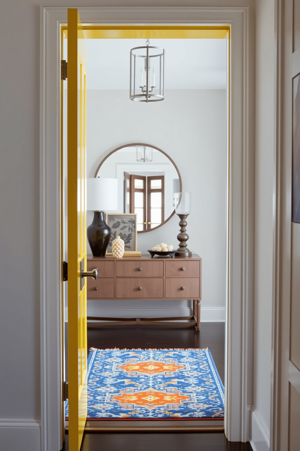 A striking foyer features a bold yellow door with sleek, contrasting hardware that draws immediate attention. Inside, the space is illuminated by natural light, highlighting a stylish console table adorned with decorative accents and a vibrant area rug that complements the door's hue.