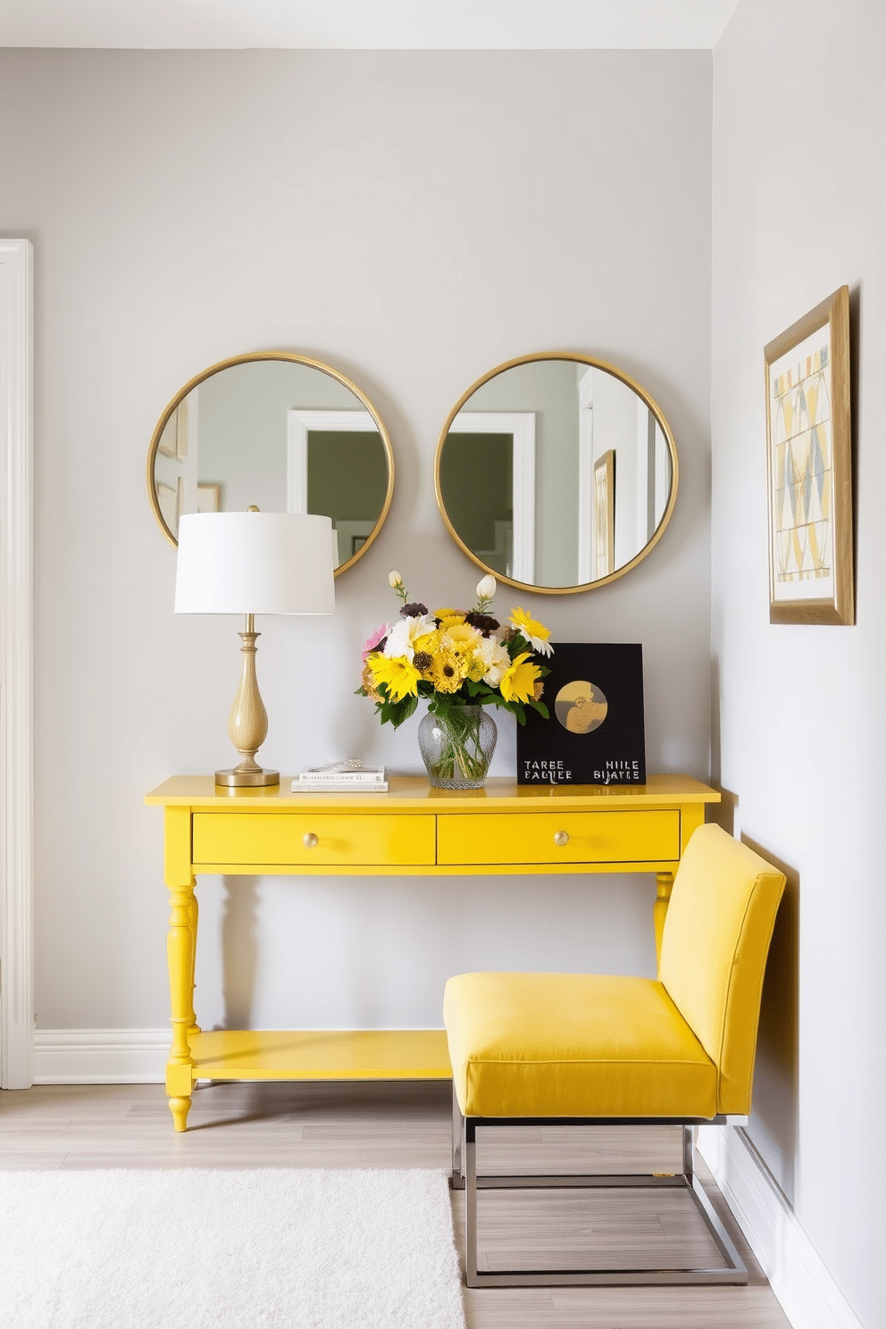 A striking yellow accent console table is positioned against a light gray wall, adorned with two round mirrors framed in gold that reflect the natural light. The table is topped with a vibrant bouquet of fresh flowers and a stylish lamp, creating a welcoming focal point in the foyer. The foyer features a soft, neutral-colored rug that complements the yellow accents, while the walls are adorned with subtle artwork that enhances the overall brightness of the space. A sleek bench in a coordinating hue provides a perfect spot for guests to sit while removing their shoes.