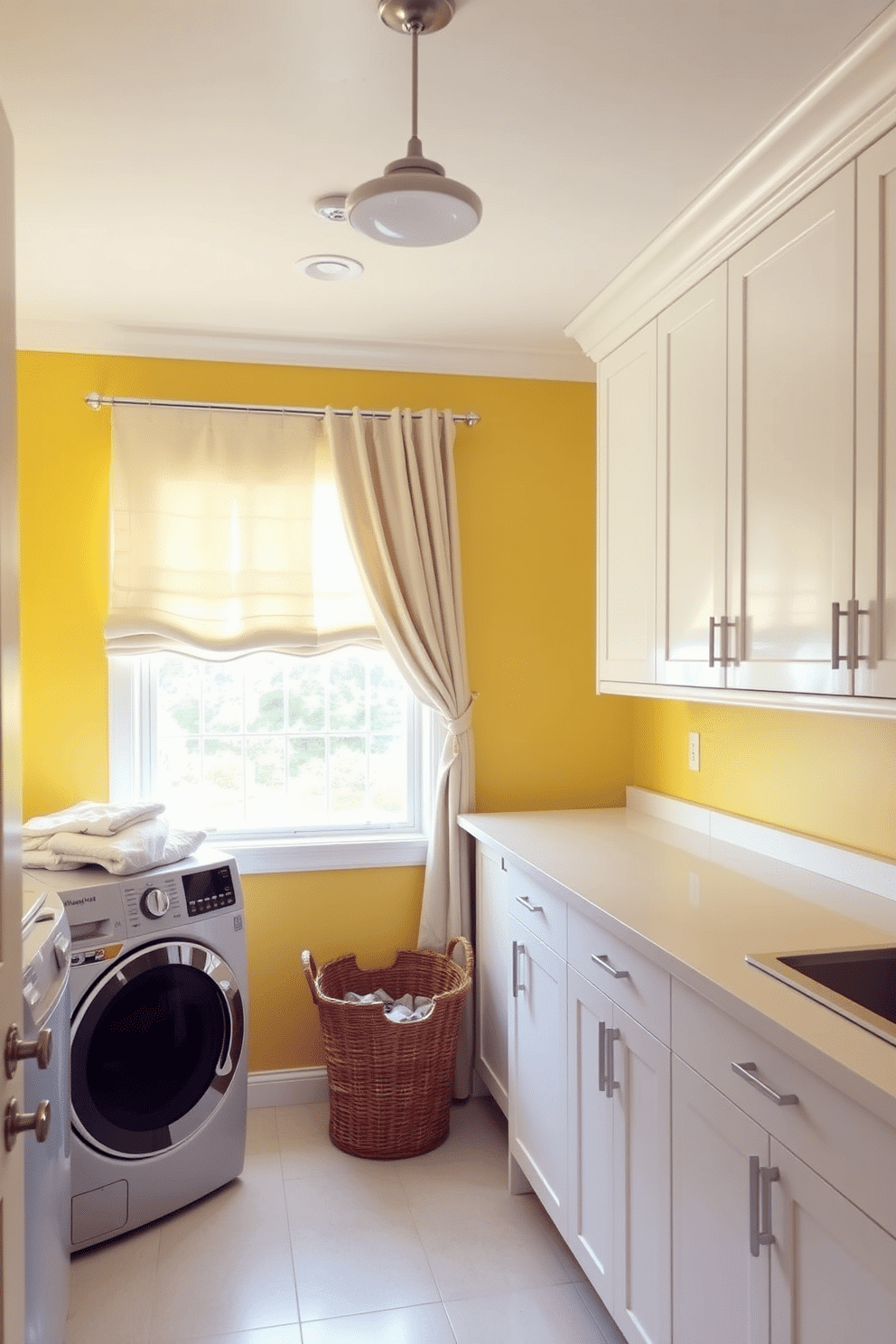 A bright yellow laundry room filled with natural light. The window treatments are soft and flowing, enhancing the cheerful atmosphere while providing privacy. The room features a spacious countertop for folding clothes, complemented by sleek white cabinetry. A basket for laundry sits invitingly in the corner, and a stylish light fixture adds a modern touch to the space.