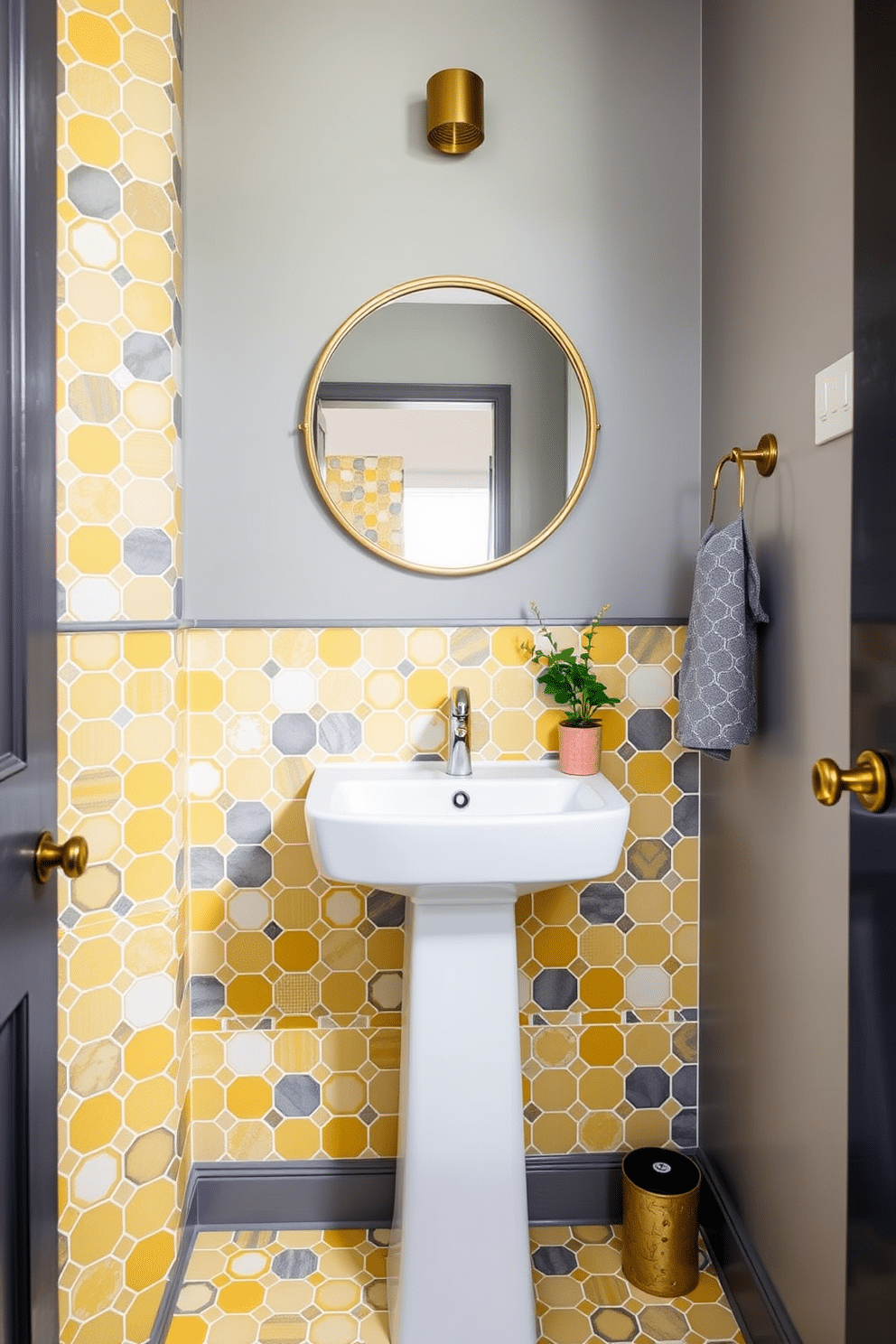 A stylish powder room featuring yellow and gray geometric tiles that create a striking visual impact. The walls are adorned with a soft gray paint, complementing the vibrant tiles and enhancing the room's brightness. The centerpiece is a sleek white pedestal sink with a modern faucet, positioned against the tiled wall. Above the sink, a round mirror with a gold frame adds a touch of elegance, while a small potted plant brings a fresh element to the design.