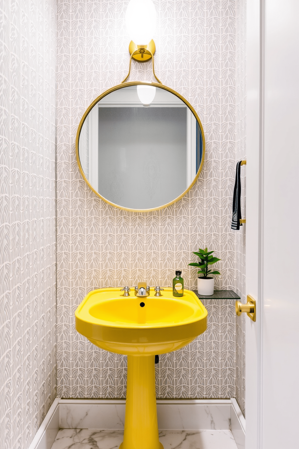 A bright yellow sink with a sleek chrome faucet serves as the centerpiece in a chic powder room. The walls are adorned with a playful geometric wallpaper in soft gray tones, creating a fresh and inviting atmosphere. A stylish round mirror with a gold frame hangs above the sink, reflecting the vibrant color of the fixture. The floor features elegant white marble tiles, complemented by a small potted plant on a nearby shelf for a touch of greenery.